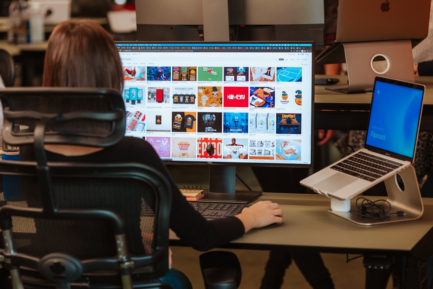 A clean desk setup with a monitor showing an AI dashboard in a modern office.