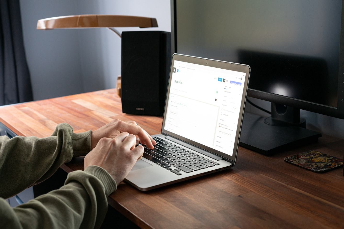 A person working on a laptop in a bright home office while planning an AI assistant project.