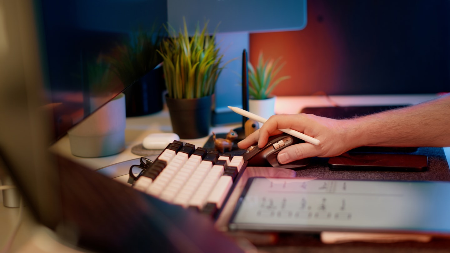 Developer and product team reviewing an AI dashboard on a monitor in a workspace