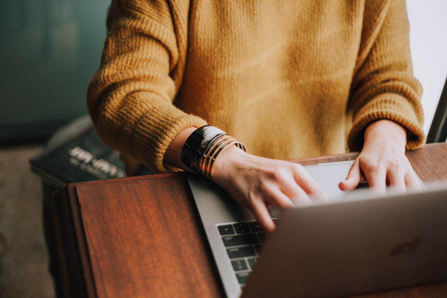 Woman browsing products on a laptop while using live chat for ecommerce support