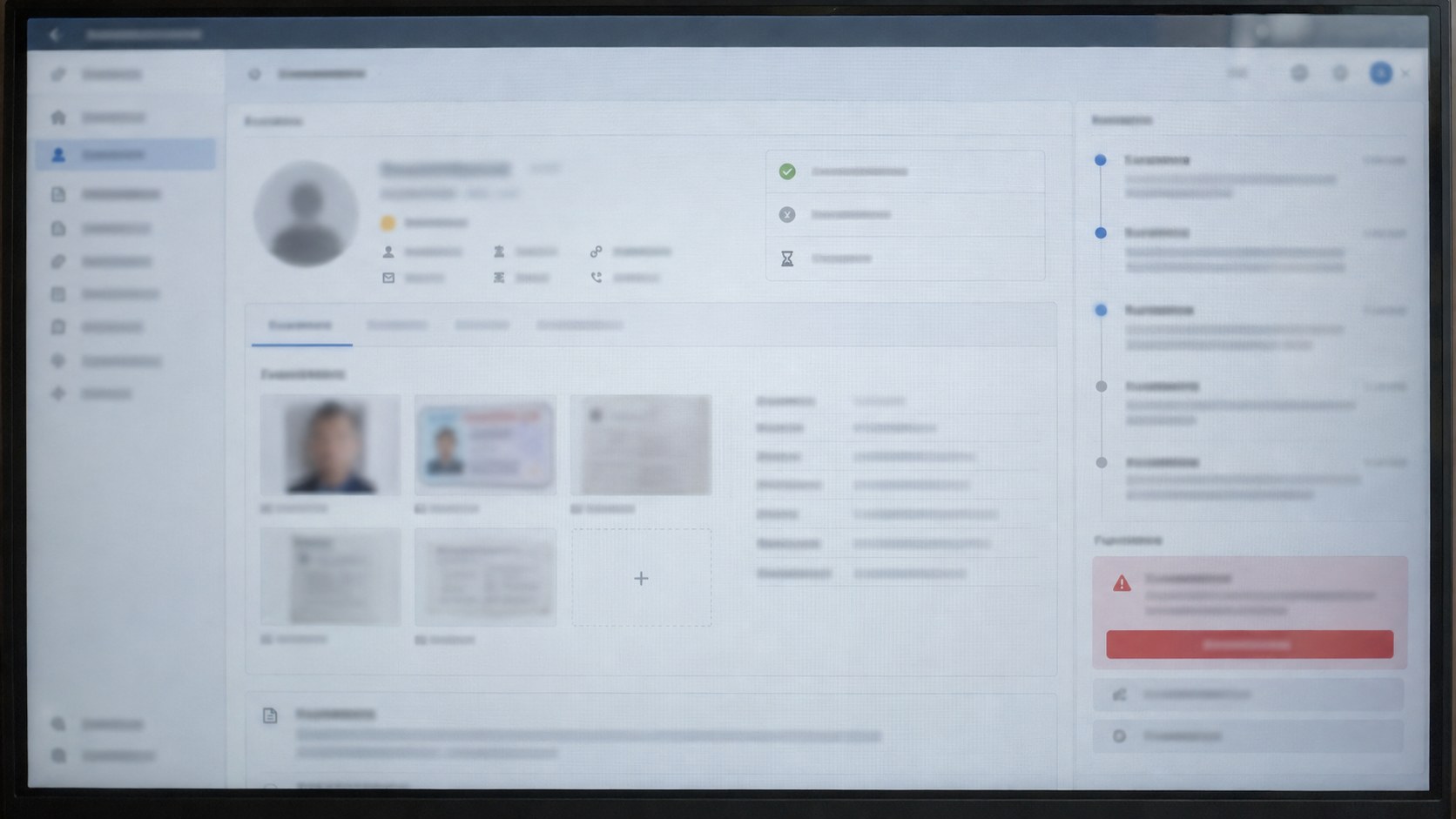 Close frontal view of a monitor displaying a blurred, unbranded creator verification case.